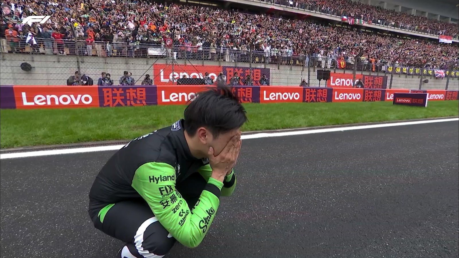 VIDEO Zhou Guanyu squatting to cry after being the first